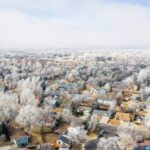 Aerial view of small suburb with snow covered trees