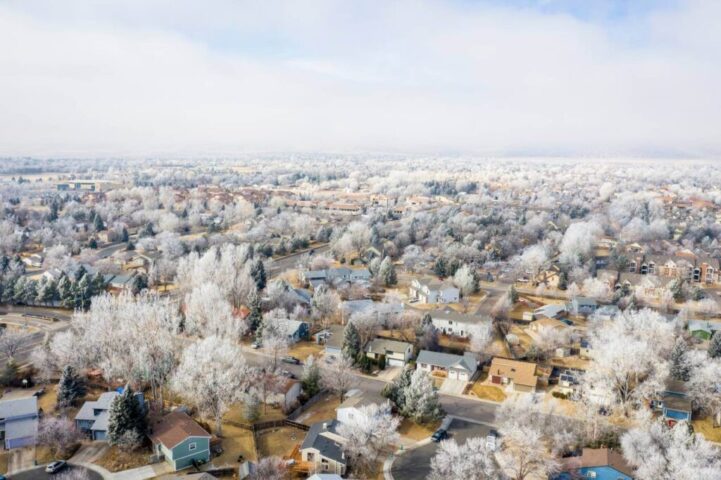 Aerial view of small suburb with snow covered trees