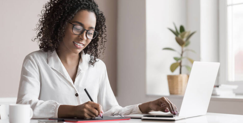 Smiling female real estate lawyer working remotely on laptop